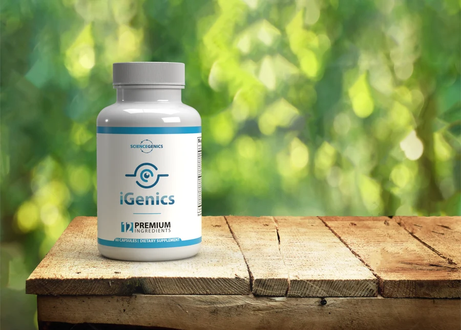 iGenics eye vitamins bottle on a wooden table with greenery behind